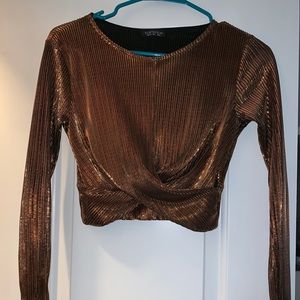 A bronze cropped long sleeve shirt